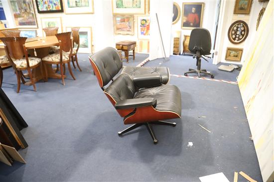 A Charles Eames cherrywood and black leather lounge chair with matching stool, made by Vitra, chair W.2ft 8in. D.2ft 8in. H.2ft 8.5in.